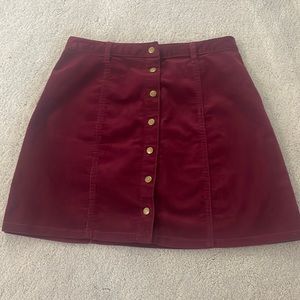 Dark plum snap front corduroy mini skirt size small.